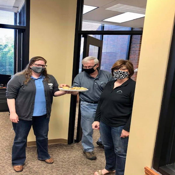 The Newton team holding a plate of cookies.