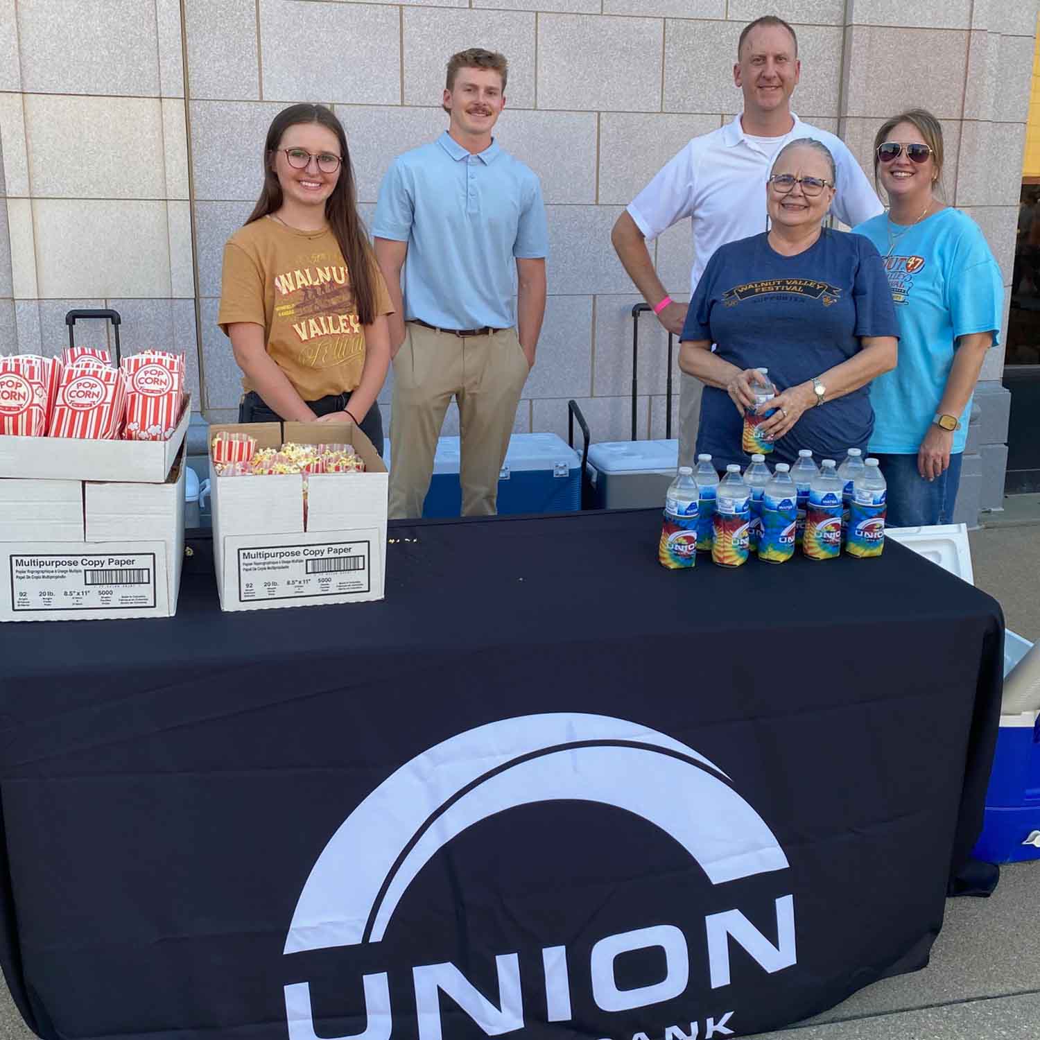 Photo of a group of Union State Bank employees at the bank's booth during a community event.