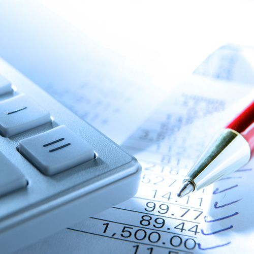 Close up image of a calculator and pen sitting on top of paperwork.