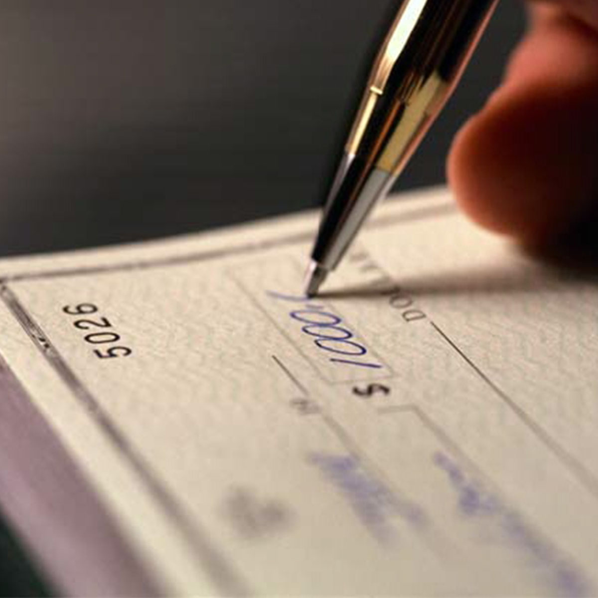 Close up of check being written. Union State Bank Positive Pay Treasury Management services.