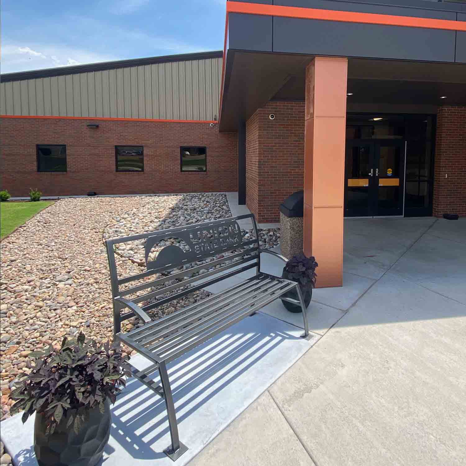 Photo of a metal park bench with the Union State Bank logo on the back.
