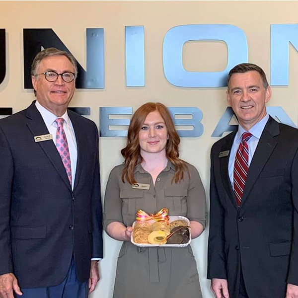 The Edmond team holding a plate of cookies.