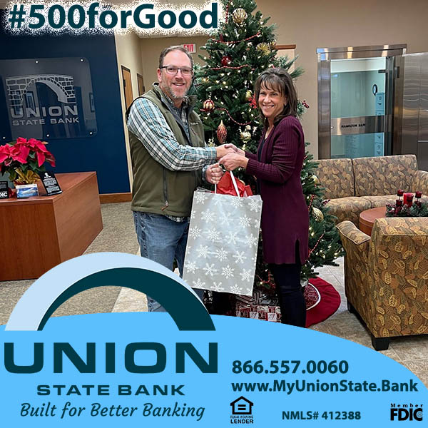 Union State Bank Loan Administrative Assistant Michelle Himes (pictured right) presents Tim Quiggle, Executive Director for Embrace of Wichita, with a donation of baby formula.