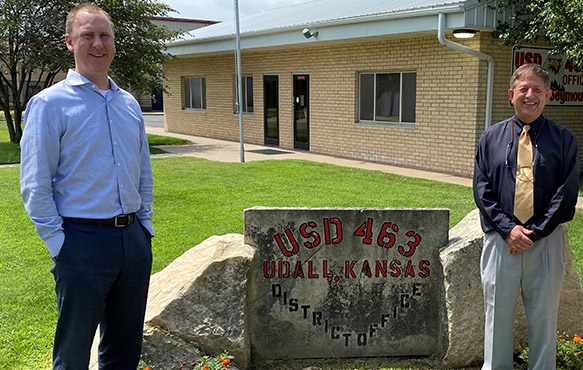 Photo of Union State Bank Udall Market President Corey Helmer with USD 463 Superintendent Dale Adams outside of the district office.
