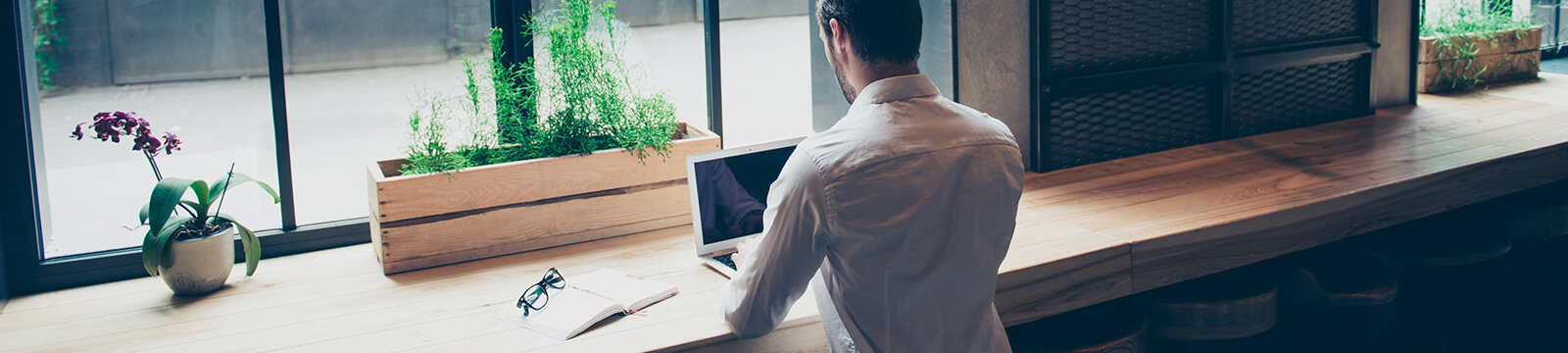 Image of man in cafe working on computer