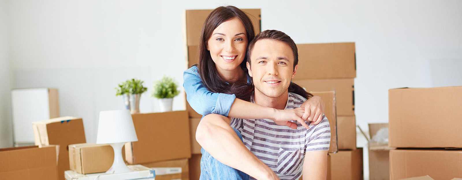 First time home buyer mortgage loan grants through Union State Bank. Young couple with unpacked boxes.