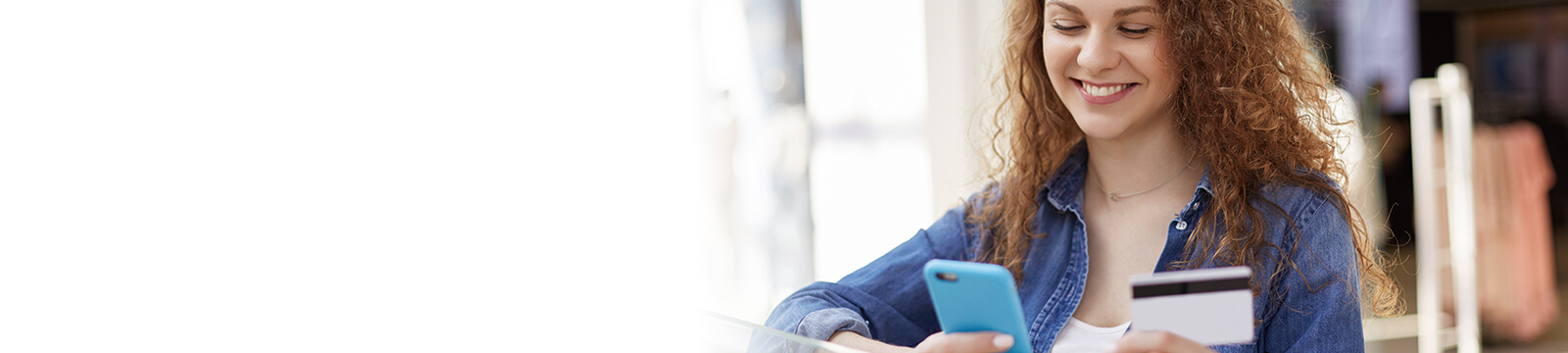 Image of woman with mobile phone and bank card