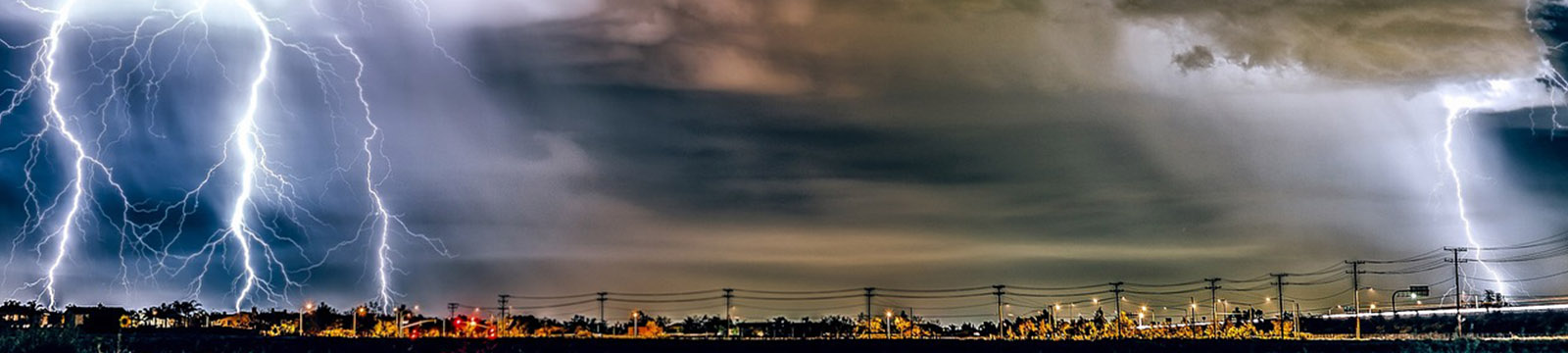 Photograph of a thunderstorm over a small town.