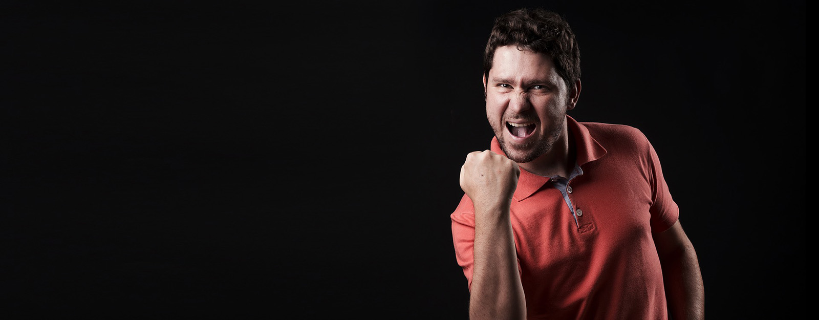 Image of a man fist pumping and cheering.