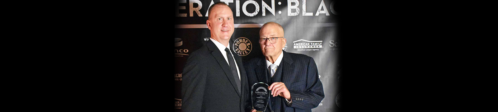 Photo of USB Market President Cory Helmer presenting the Healthcare Hero award to Dick Vaught.