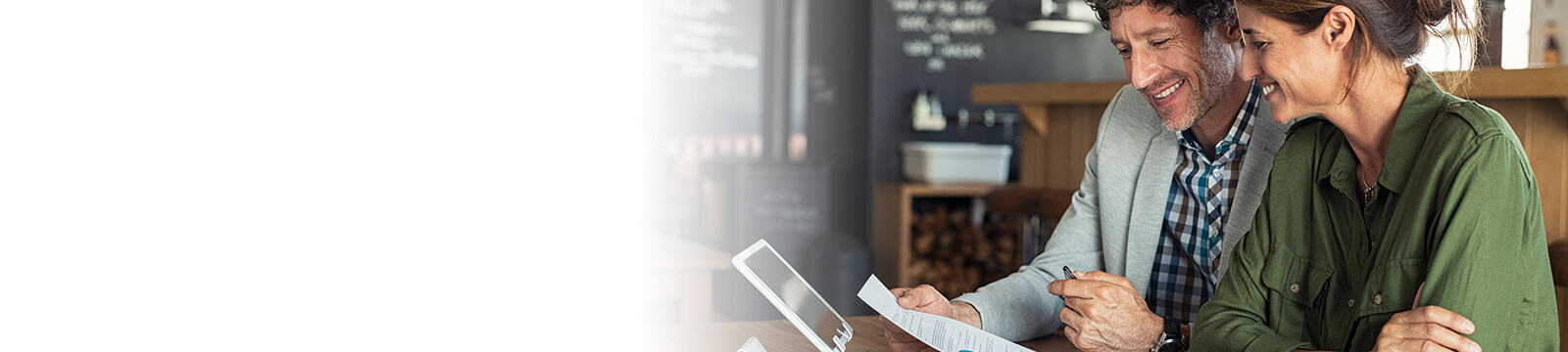 Image of man and woman working together on tablet