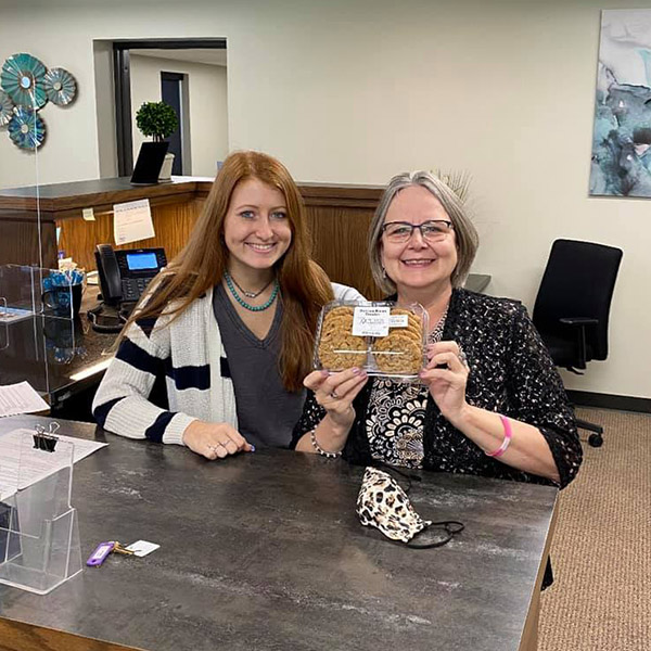 The Udall team holding a box of cookies.