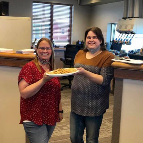 The Newton South team holding a plate of cookies.