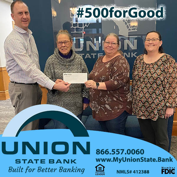 Union State Bank's Cory Helmer and Amanda Conrad present a check to members of Angels in the Attic.