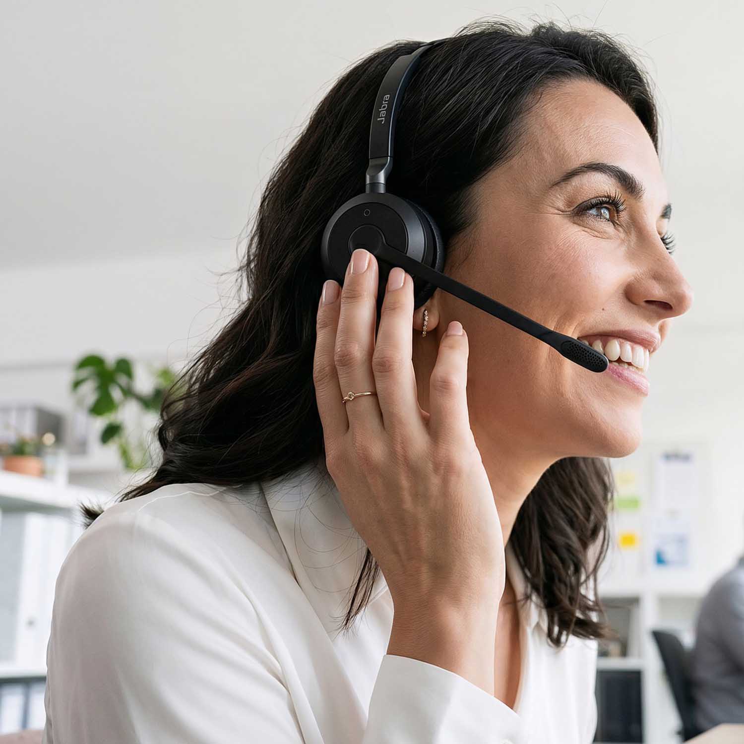 Image of an office worker speaking through a headset.
