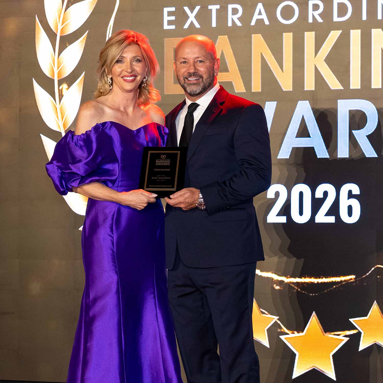 Photo of USB CEO Eric Kurtz being presented a 2026 Banky award.