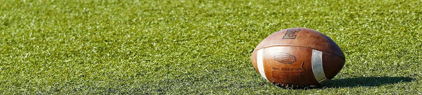 Photo of a football on a field.